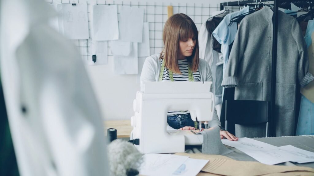 A seamstress is working on a sewing machine.
