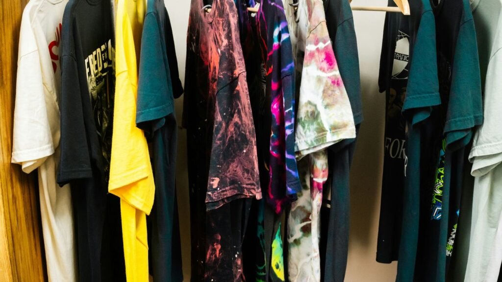 Assortment of t-shirts hanging on a rack.